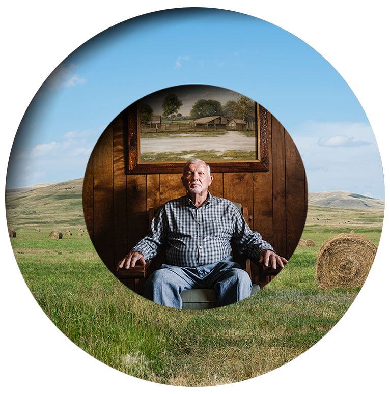 An elderly man in a checked shirt sits indoors by a wooden wall and farm painting, overlaid on a field with hay bales and hills.