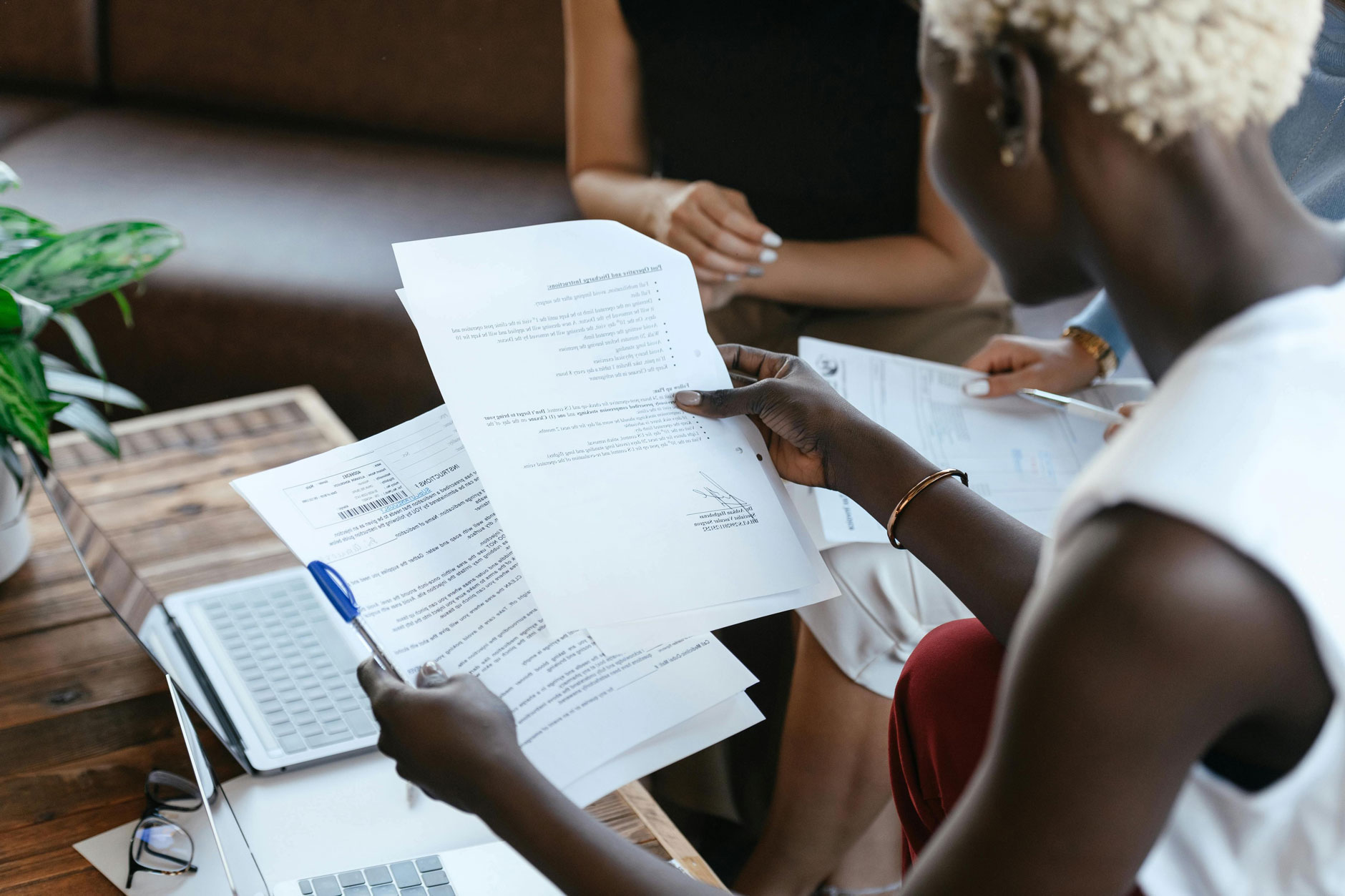A circular image features a faded black-and-white photo of children layered over a color landscape with shrubs and distant mountains.